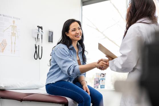 Woman shaking her doctors hand before a breast cancer screening